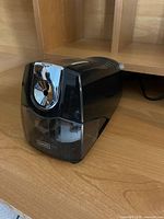 Front and side view of electric pencil sharpener on desk