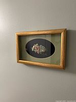 Front view of the framed 3D floral artwork hanging on wall