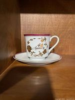Teacup and saucer showing gold floral design and '40th Anniversary' text