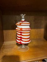 Full view of striped glass lidded container