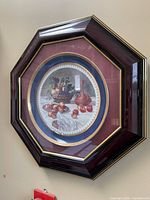 Octagonal wood frame containing round ceramic plate with fruit still life design