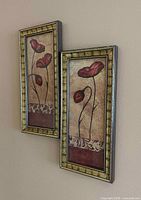 Two matching framed poppy prints hanging on wall