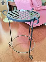 Full view of the wrought iron table showing legs and stretcher