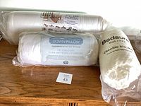 Three sealed bedding items on surface