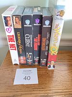 Front spines of all six VHS tapes standing on shelf