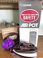 Group shot showing air pot box, lantern box, safety glasses, earmuffs, corded appliance