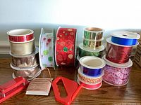Group of ribbon spools showing variety of colors, materials and sizes