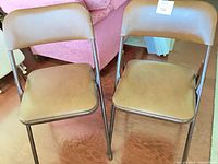 Front view of both brown folding chairs