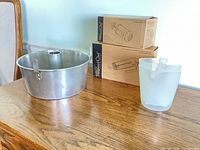 Angel food pan, boxed Pampered Chef tools, pitcher on table