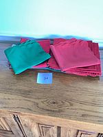 Stacked red and green scalloped edge napkins on table
