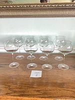 Full set of eight balloon wine glasses arranged on table