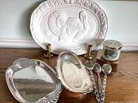 Group shot showing all serving pieces, spoons, candlesticks and candle