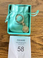 Keychain in Tiffany pouch inside box with auction tag