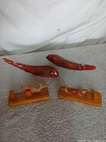 Two large koi fish and two small fish on bases displayed together