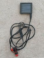 Front display of iPod nano in case with attached earbuds