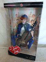 Front view of boxed I Love Lucy Barbie doll with cello
