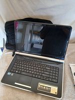 Gateway NV79 laptop open with case behind