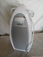 Front angled view showing overall purifier, power cord, gray grill