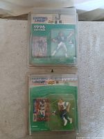 Both sealed action figures in protective cases