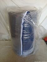 Rolled memory foam topper in original plastic wrap