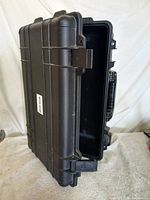 Closed Tuff Protection rolling hard case standing upright showing exterior ribs, side handle and wheels