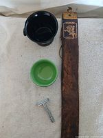 Overview of all four items: strop, black mug, green-interior bowl, safety razor