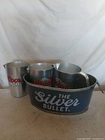 Overall view showing ice bucket and three pitchers with Coors Light branding