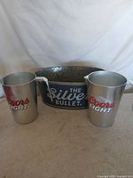 Front view of bucket and two pitchers