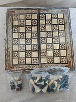 Folding inlaid wooden board with two bags of game pieces