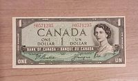 Obverse of 1954 Canadian one-dollar note showing serial number, portrait, signatures