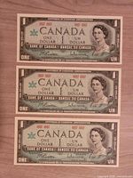 Obverse of three 1967 Canadian $1 notes