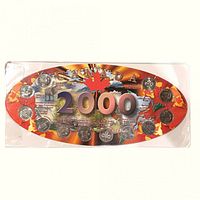 Front of oval display card showing twelve 2000 Millennium 25-cent coins and Canada 2000 graphics
