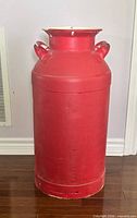 Full view of red metal milk can front