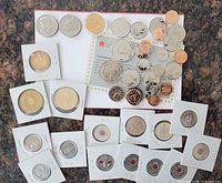 Overall lot showing loose coins, proof-like coins on RCM card, coins in flips