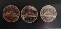 Three 1968 voyageur dollars reverse side showing canoe design