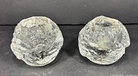 Front view of both textured glass snowball votive holders