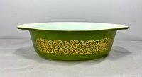 Side view showing green exterior and gold scroll pattern
