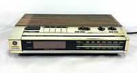 Front view showing brand, model, display, AM/FM scale and controls
