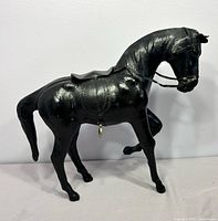 Full left side view of leather horse figurine