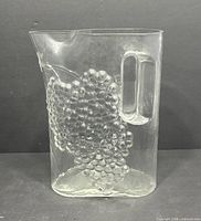 Front view showing overall shape, grape relief, handle, spout