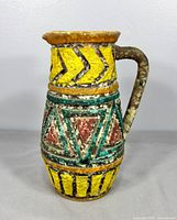 Front view of pottery vase showing geometric pattern and handle