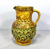 Front view of Jasba pottery pitcher vase showing handle, relief pattern and glaze