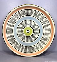 Full view of ceramic plate-bowl showing entire decorative design and rim