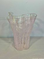 Front view of pink ruffled glass vase