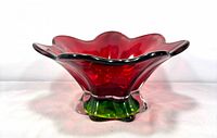Front view of ruby red ruffled bowl with green pedestal