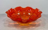 oblique view of orange double-ruffled bowl showing external contours