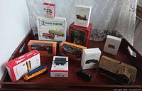 Tray overview of boxed train ornaments and loose station