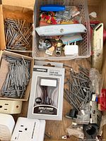 Drawer with nails, screws, charger package, adapters, mixed hardware