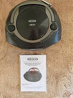 Top view of Jensen CD-560 player showing CD lid, controls and antenna
