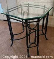 Three-quarter view showing octagonal glass top and metal frame